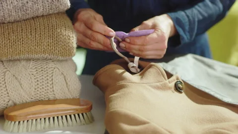 Adding Scented Sachet for Wardrobe Moth Protection Stock-Footage 330921986