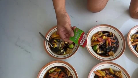 Adding seasoning to vegetable and dish. Satay seasoning. Stock Footage 279445577