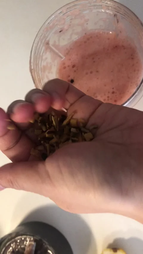 Adding Seeds To Red Pink-Colored Beverage Close-Up Food Texture Background Stock-Footage 331944616