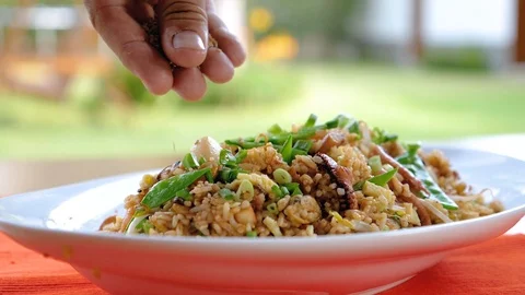 Adding Sesame Seeds on a Fried Rice with Calamari Stock Footage 85861471