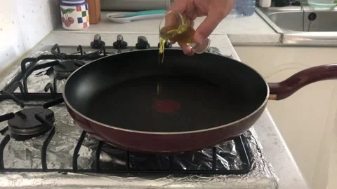 Adding A Shot Of Olive Oil In A Pan Stock Footage 130916115