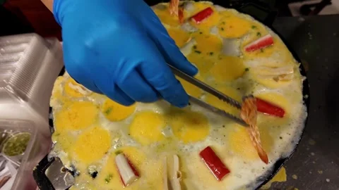 Adding Shrimp to a Thai Egg Dish During Street Food Preparation Stock Footage 342500624