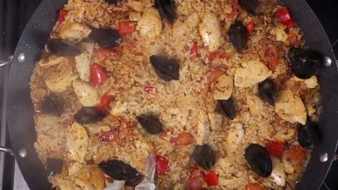 Adding Shrimps To Seafood and Chicken Paella Stock Footage 82973965