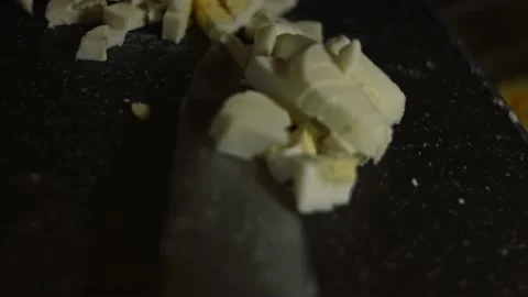 Adding sliced hard boiled eggs into a bowl with salad. Preparing salad of crab Stock Footage 150236229