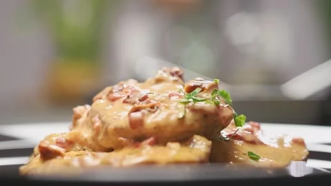 Adding sliced parsley on a pork with sun-dried tomatoes, served on a plate. Stock Footage 154939318
