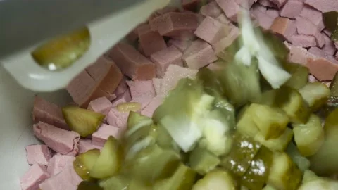 Adding sliced pickled cucumber and boiled eggs to the pot on sliced boiled s Vídeos de archivo 231199214