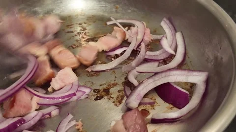 Adding Sliced Red Onion to a Frying Pan Video stock 348108923