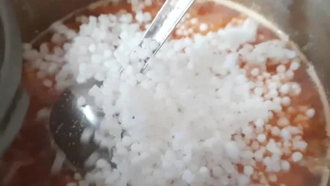 Adding Soaked Sabudana to Spiced Mixture – Indian Cooking Process Close-Up Video stock 332986277