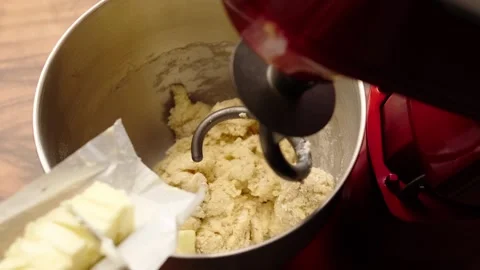 Adding soft butter to a yeast dough in a stand mixer Stock Footage 281460080