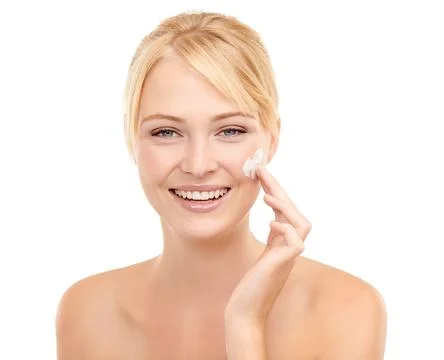 Adding some moisture to that beautiful skin. Portrait of a beautiful young woman Stock Photos