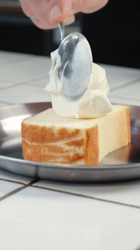 Adding Sour Cream to Cottage Cheese Cake Slice Stock Footage 342924319