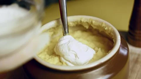 Adding Sour Cream to Mashed Potatoes — Overhead View Stock Photos