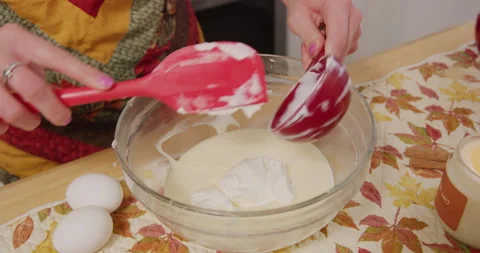 Adding sour cream into mix in mixing bowl with spatula Stock Footage 249322045