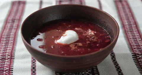 Adding sour cream to red borscht Stock Footage