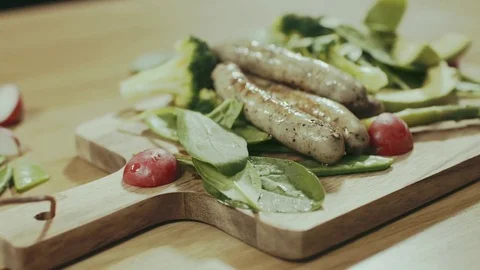 Adding sousages on salads Stock Footage 76602513