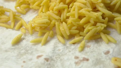 Adding Spanish rice onto a tortilla for a burrito Stock Footage 315417464