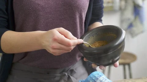 Adding spice to soup Stock Footage 140268854