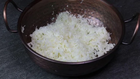 Adding spices  and herbs to grated Cauliflower to make Cauliflower Rice. Stock Footage 128778690