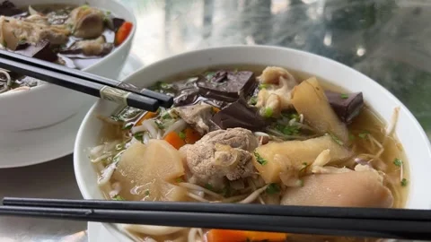 Adding spices to beef noodle soup bowls Stock Footage 316079053
