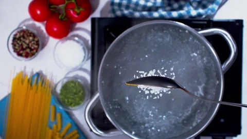 Adding spices to the boiling water closeup in super slow motion 1000fps Stock Footage 257062953