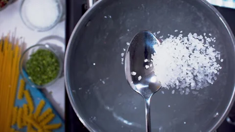 Adding spices to the boiling water closeup in super slow motion 1000fps Stock Footage 257063043