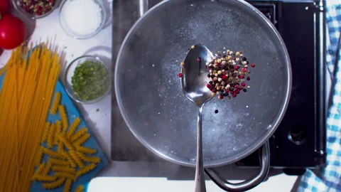 Adding spices to the boiling water closeup in super slow motion 1000fps Stock Footage 257063189