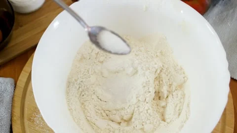 Adding spices to flour. Preparing a baking mixture. Stock Footage 315028542