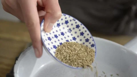 Adding spices to pan Stock Footage 140268818