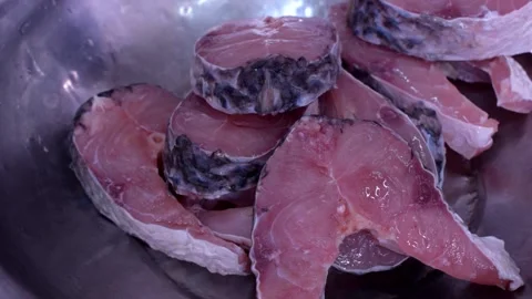 Adding Spices To Raw Fish for Fish Curry Preparing Stock Footage 160649122