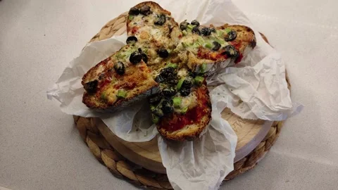 Adding Spices to Sauced Breads Standing on Wooden Floor Stock Footage 144045385