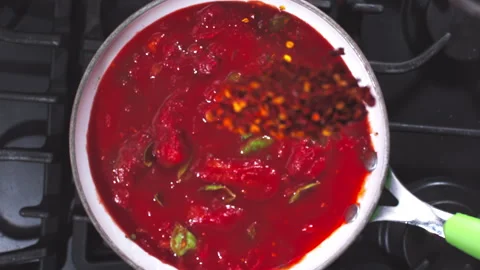 Adding spices to the tomato sauce closeup in super slow motion 1000fps Stock Footage 257061780