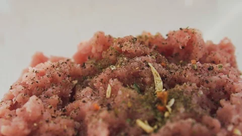 Adding spices on top of forcemeat, slow motion. Stock Footage