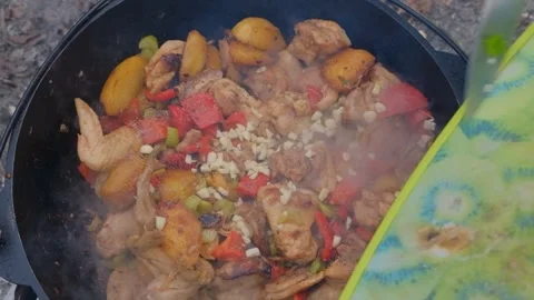 Adding spices when cooking. The cook pours spices into the dish. Spices are Stock Footage 280213806