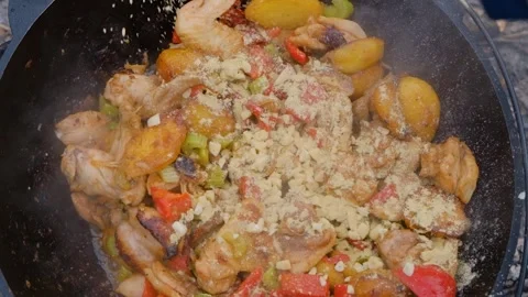 Adding spices when cooking. The cook pours spices into the dish. Spices are Stock Footage 280213812