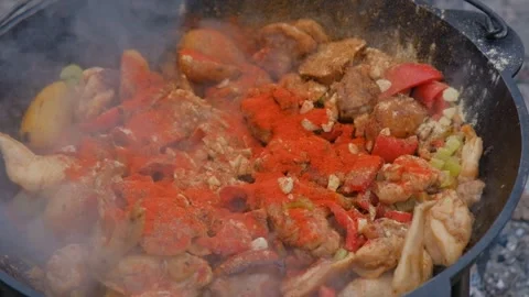 Adding spices when cooking. The cook pours spices into the dish. Spices are Stock Footage 280354910