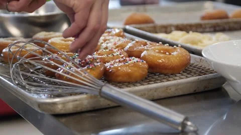 Adding sprinkles into the prepared donuts Stock-Footage 307339989