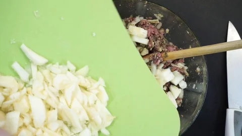 Adding squash flesh to minced meat overhead Stock Footage 119781044
