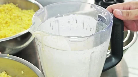 Adding steamed yellow split mung beans into a blender jar. Stock Footage 346605563