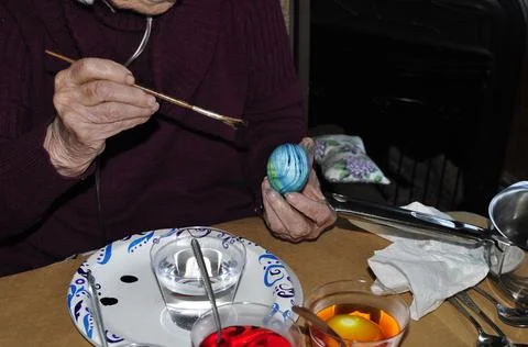 Adding Stripes to a Beautiful Blue Easter Egg Foto stock