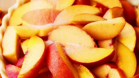 Adding sugar and cinnamon to peach slices Stock Footage 79228848