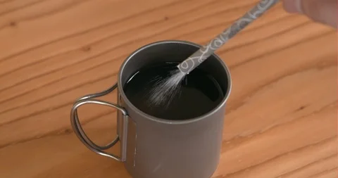 An adding sugar and mixing coffee of work tools in office Stock Footage 122089962