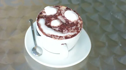 Adding sugar to cappuccino and mixing with a spoon Stock Footage 68379902