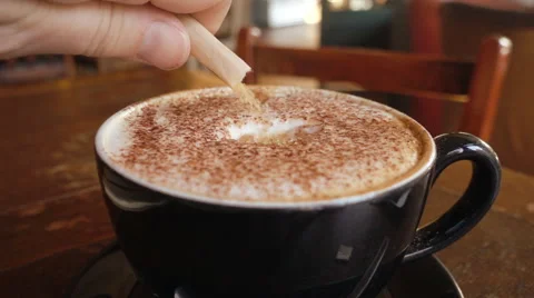 Adding sugar to cappuccino, slow motion Stock Footage 55373537