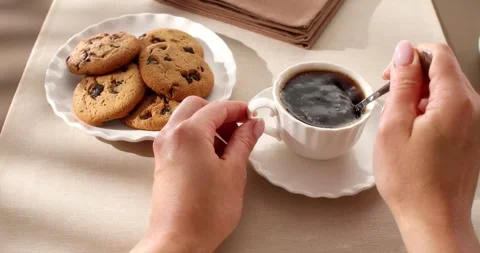 Adding sugar to coffee and stiring. Person view. Slow camera slide. Stock Footage 242590079