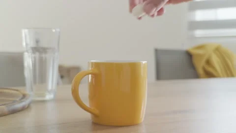 Adding Sugar to Coffee in Yellow Mug. Stock Footage 278461670