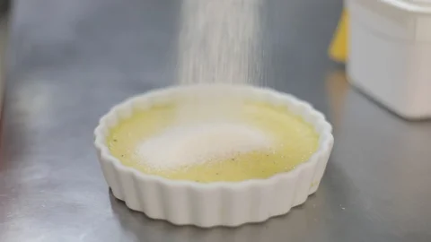 Adding Sugar on a Creme Brulee Stock Footage 129327437