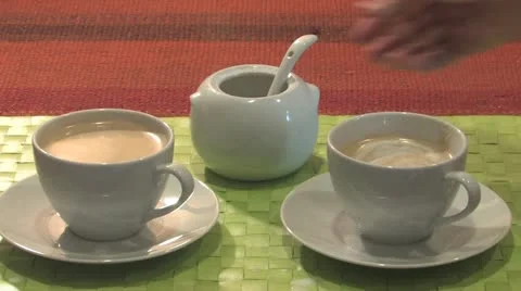 Adding sugar to a cup of coffee and stirring the coffee Stock Footage 11877484
