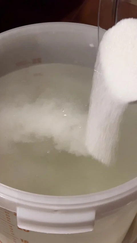 Adding Sugar to Fermentation Mash for Moonshine. Stock Footage 301345872