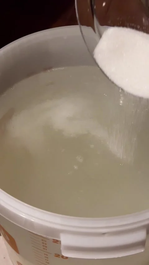 Adding Sugar to Fermentation Mash for Moonshine. Stock Footage 301345916