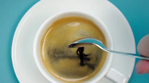 Adding sugar to fresh coffee Stockbeeldmateriaal 156996661